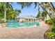 Scenic pool surrounded by palm trees, buildings and tropical plants at 3702 54Th W Dr # 104, Bradenton, FL 34210