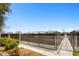 Outdoor tennis courts are surrounded by tall black fencing with walkway at 3702 54Th W Dr # 104, Bradenton, FL 34210