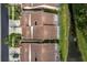 An aerial view of a neighborhood featuring screened patios and well-manicured lawns at 3875 Darston St, Palm Harbor, FL 34685