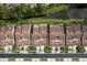 A street of townhomes with tile roofs featuring driveways and manicured landscaping at 3875 Darston St, Palm Harbor, FL 34685