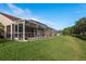 A long screened lanai provides ample outdoor living space with scenic backyard views at 3875 Darston St, Palm Harbor, FL 34685