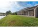 A spacious, screened lanai is adjacent to a pond, creating a peaceful outdoor retreat at 3875 Darston St, Palm Harbor, FL 34685
