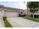 Charming home featuring a well-manicured lawn and a spacious two-car garage, complemented by a stylish red-tiled roof at 3875 Darston St, Palm Harbor, FL 34685