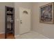 Bright entryway featuring neutral walls, tile flooring, and a stylish decorative shelf, leading into the home at 3875 Darston St, Palm Harbor, FL 34685