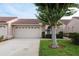 Charming home featuring a well-manicured lawn and a spacious two-car garage, complemented by a stylish red-tiled roof at 3875 Darston St, Palm Harbor, FL 34685