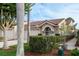 Attractive home featuring a two-car garage, landscaped yard with mature trees, and a striking red-tiled roof at 3875 Darston St, Palm Harbor, FL 34685