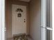 Close-up of a charming front door, featuring decorative details and a cheerful welcome sign, inviting guests inside at 3875 Darston St, Palm Harbor, FL 34685