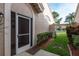 Welcoming entrance showcasing a charming door, surrounded by lush landscaping and offering a glimpse into the community beyond at 3875 Darston St, Palm Harbor, FL 34685