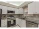 Functional kitchen with stainless steel appliances and ample counter space, ready for meal preparation at 3875 Darston St, Palm Harbor, FL 34685