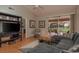 Bright living room features a plush sectional sofa, modern decor, and a sliding glass door with backyard views at 3875 Darston St, Palm Harbor, FL 34685