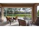 Screened patio area featuring comfortable seating arrangements and views of a serene waterway and landscaping at 3875 Darston St, Palm Harbor, FL 34685