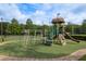 A colorful playground area with slides and jungle gym set on a green lawn at 3875 Darston St, Palm Harbor, FL 34685