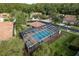 Community pool area with chairs, lush landscaping, and covered area at 3875 Darston St, Palm Harbor, FL 34685