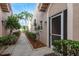 Inviting walkway surrounded by lush landscaping leading to the entrance, adorned with charming exterior lighting and a welcome mat at 3875 Darston St, Palm Harbor, FL 34685