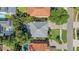 Overhead view showing surrounding houses, swimming pool, driveway, lawn and tree coverage at 3903 W De Leon St, Tampa, FL 33609