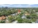 Wonderful aerial showcasing homes in a lush, established neighborhood with a distant city skyline at 3903 W De Leon St, Tampa, FL 33609