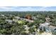 Aerial view of a residence nestled amongst a dense tree canopy in an urban setting at 3903 W De Leon St, Tampa, FL 33609