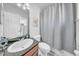Clean bathroom featuring a shower with a curtain, toilet, and a vanity with black marble at 3903 W De Leon St, Tampa, FL 33609
