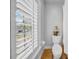 Bathroom with shuttered window beside toilet and shower featuring a curtain for privacy at 3903 W De Leon St, Tampa, FL 33609