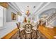 Formal dining room with a glass table, chandelier, and views of the staircase at 3903 W De Leon St, Tampa, FL 33609