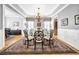 Elegant dining room with a glass table, chandelier, and large rug for sophisticated gatherings at 3903 W De Leon St, Tampa, FL 33609