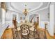 Elegant dining room with a round table, chandelier, and doorway to the kitchen at 3903 W De Leon St, Tampa, FL 33609