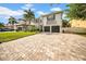 Charming two-story home with a spacious brick driveway and a beautifully landscaped front yard at 3903 W De Leon St, Tampa, FL 33609