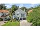 Charming two-story home featuring a brick driveway, well-manicured lawn, and inviting curb appeal at 3903 W De Leon St, Tampa, FL 33609