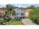 Elegant two-story home featuring a manicured lawn, paver driveway, and a two-car garage at 3903 W De Leon St, Tampa, FL 33609