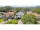 Aerial view of a house, showing landscaping, paver driveway and lush surrounding trees at 3903 W De Leon St, Tampa, FL 33609