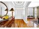Bright foyer with hardwood floors, a decorative table, and a view into the living area at 3903 W De Leon St, Tampa, FL 33609