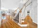 Grand foyer featuring a staircase, hardwood floors, and an open view into the living spaces at 3903 W De Leon St, Tampa, FL 33609