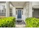 Inviting front entrance with a stylish blue door and well-maintained landscaping at 3903 W De Leon St, Tampa, FL 33609