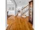 Spacious hallway showcasing hardwood floors, white trim, staircase, and open access to the dining room at 3903 W De Leon St, Tampa, FL 33609