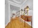 Inviting entryway with hardwood floors, a decorative table, and arched doorway for a welcoming atmosphere at 3903 W De Leon St, Tampa, FL 33609