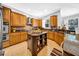 Bright kitchen with an island, wooden cabinets, stainless steel appliances, and elegant countertops at 3903 W De Leon St, Tampa, FL 33609