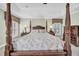 A view of the main bedroom featuring a carved, four-poster bed at 3903 W De Leon St, Tampa, FL 33609