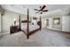 Bright main bedroom featuring a king size bed, ceiling fan and neutral carpet flooring at 3903 W De Leon St, Tampa, FL 33609
