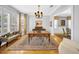 Elegant office with a wooden desk, chandelier, and large windows with shutters at 3903 W De Leon St, Tampa, FL 33609