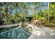 Lush backyard oasis featuring a private pool, spa, and tropical landscaping at 3903 W De Leon St, Tampa, FL 33609