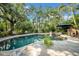 Lush backyard oasis featuring a private pool, spa, and tropical landscaping for ultimate relaxation at 3903 W De Leon St, Tampa, FL 33609