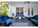 Inviting covered porch with cozy seating, perfect for relaxing and enjoying the outdoors at 3903 W De Leon St, Tampa, FL 33609