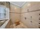 Spacious walk-in shower with tile surround, multiple shower heads, and a comfortable wooden bench at 3903 W De Leon St, Tampa, FL 33609