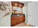 Bathroom vanity area featuring a dark wood cabinet, granite countertop, and decorative mirror at 3903 W De Leon St, Tampa, FL 33609
