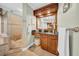 Bathroom with a granite countertop, wooden vanity with framed mirror and a walk-in shower nearby at 3903 W De Leon St, Tampa, FL 33609