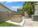 Outdoor hot tub on a concrete pad, surrounded by a wooden fence and tropical greenery, offering a private retreat at 4021 Vana Dr, Sarasota, FL 34241