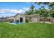 A backyard with a patio, dining set, grill, and basketball area offering ample space for outdoor activities at 4021 Vana Dr, Sarasota, FL 34241
