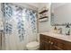 Bathroom featuring vanity with dark wood cabinetry and bathtub with leaf-patterned shower curtain at 4021 Vana Dr, Sarasota, FL 34241