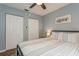 Bedroom featuring ceiling fan, closets, comfortable bed, and soft, neutral color palette at 4021 Vana Dr, Sarasota, FL 34241