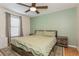 This primary bedroom features neutral decor and a ceiling fan, perfect for a restful retreat at 4021 Vana Dr, Sarasota, FL 34241